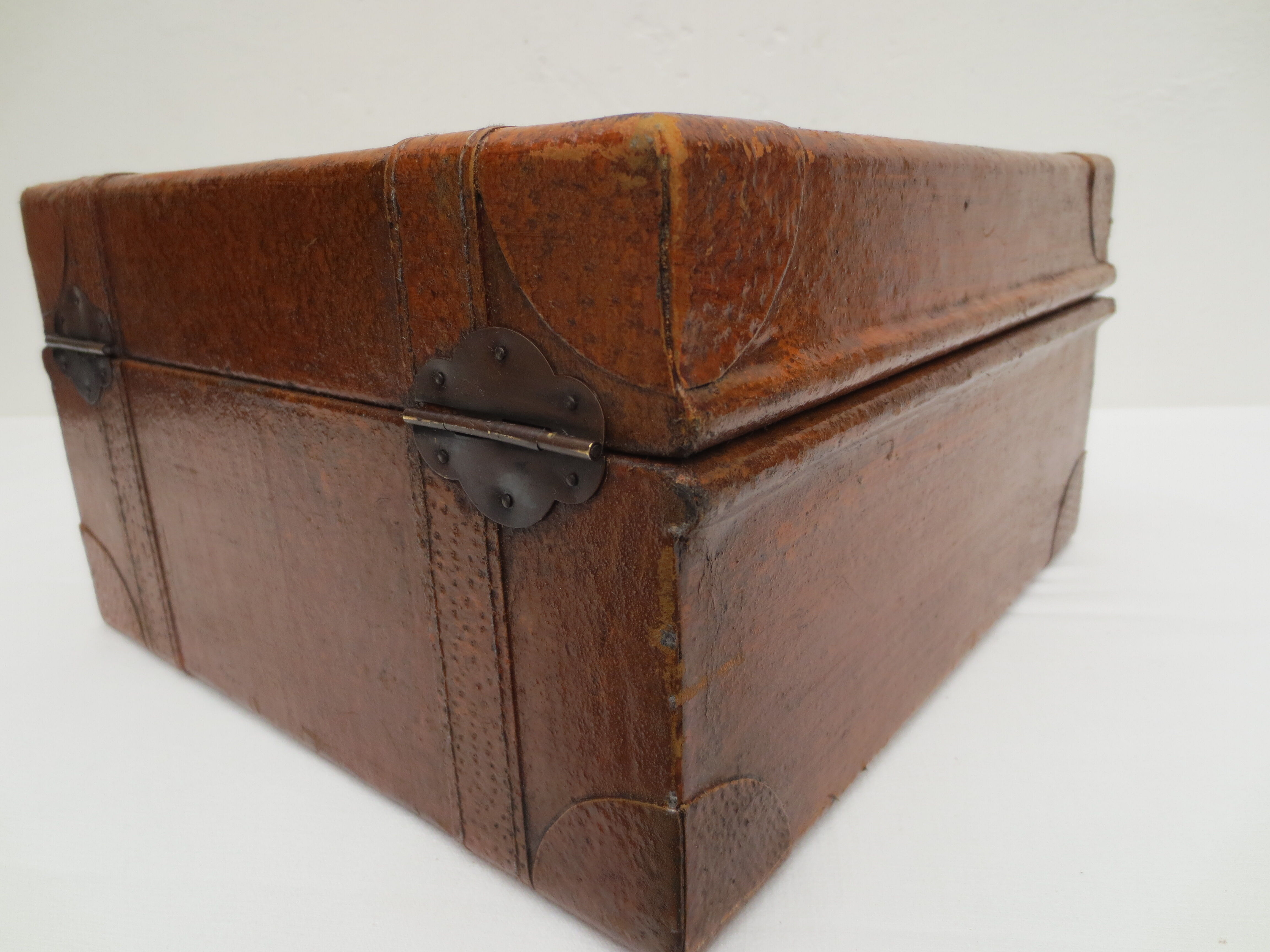 Rectangular wooden suitcase covered with leather