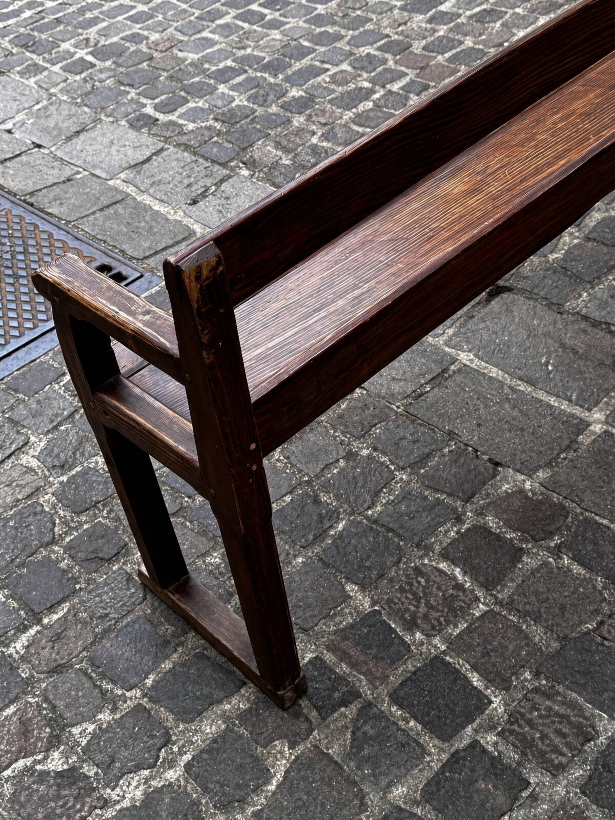 Old wooden bench with backrest and armrests