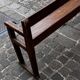 Old wooden bench with backrest and armrests