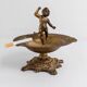 Vintage brass ashtray from the 1940s with a nude boy figurine on a footed base.