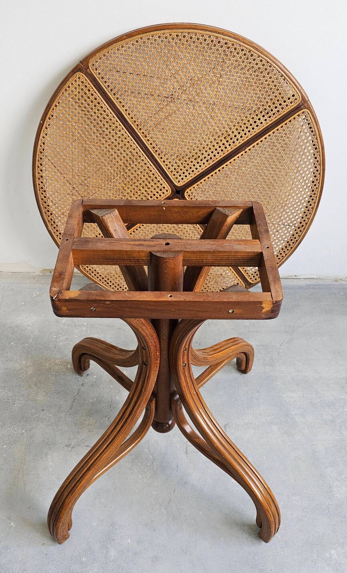 Round dining table in curved wood with a rattan top by Mundus, 1960s.