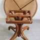 Round dining table in curved wood with a rattan top by Mundus, 1960s.