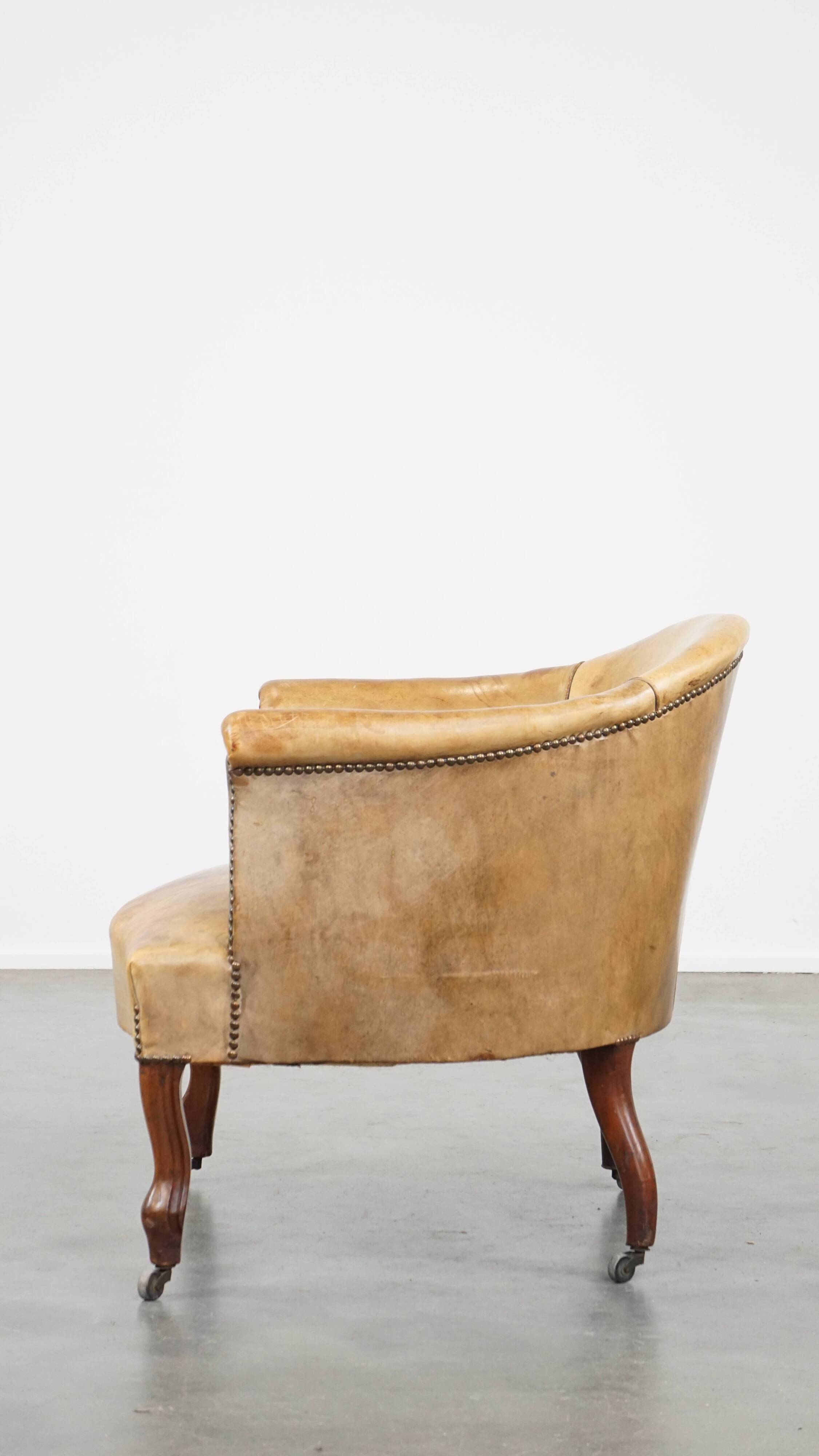 Antique sheep leather club chair/armchair on wheels