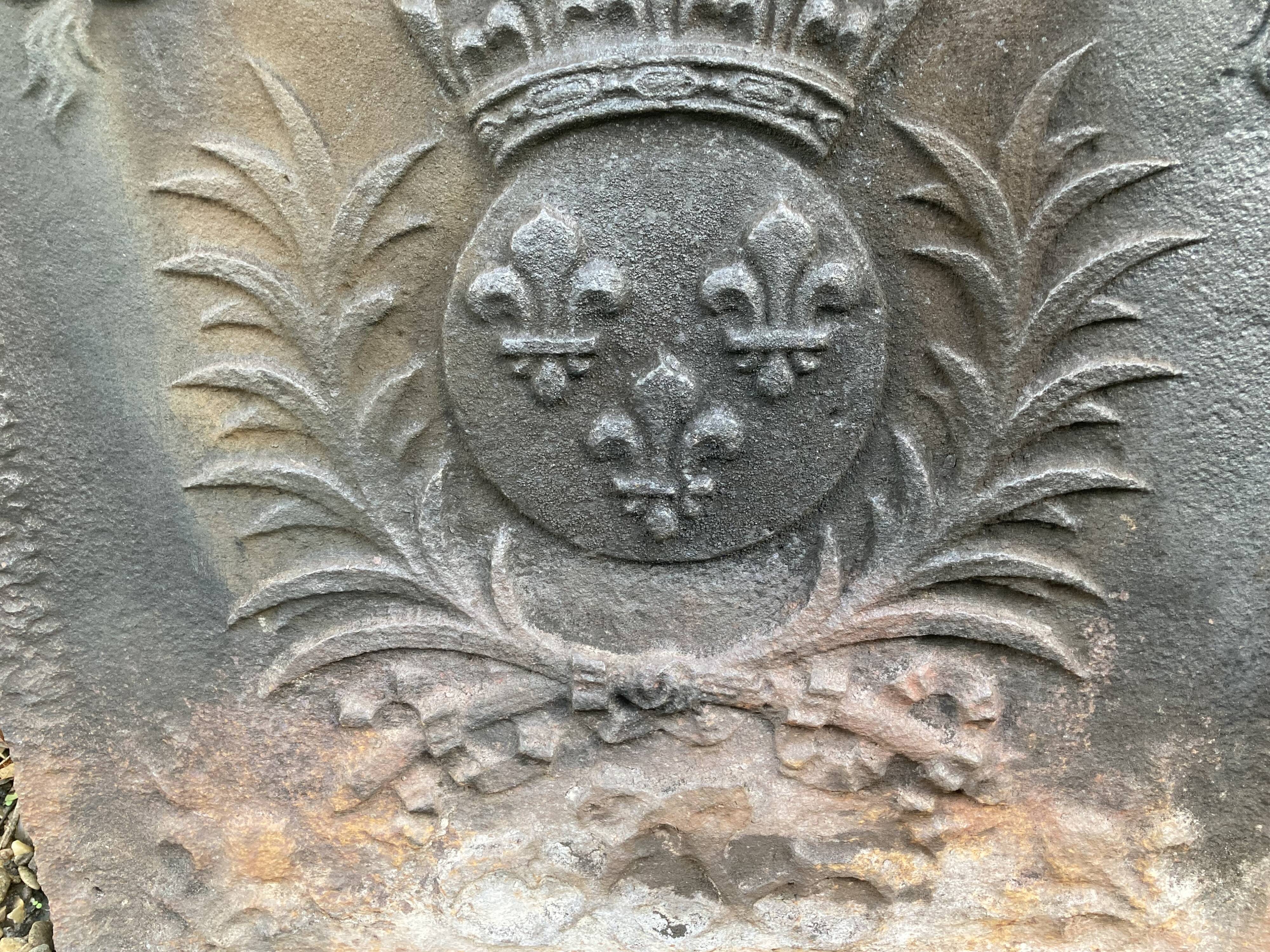 Old cast iron fireback with royal coat of arms
