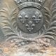 Old cast iron fireback with royal coat of arms