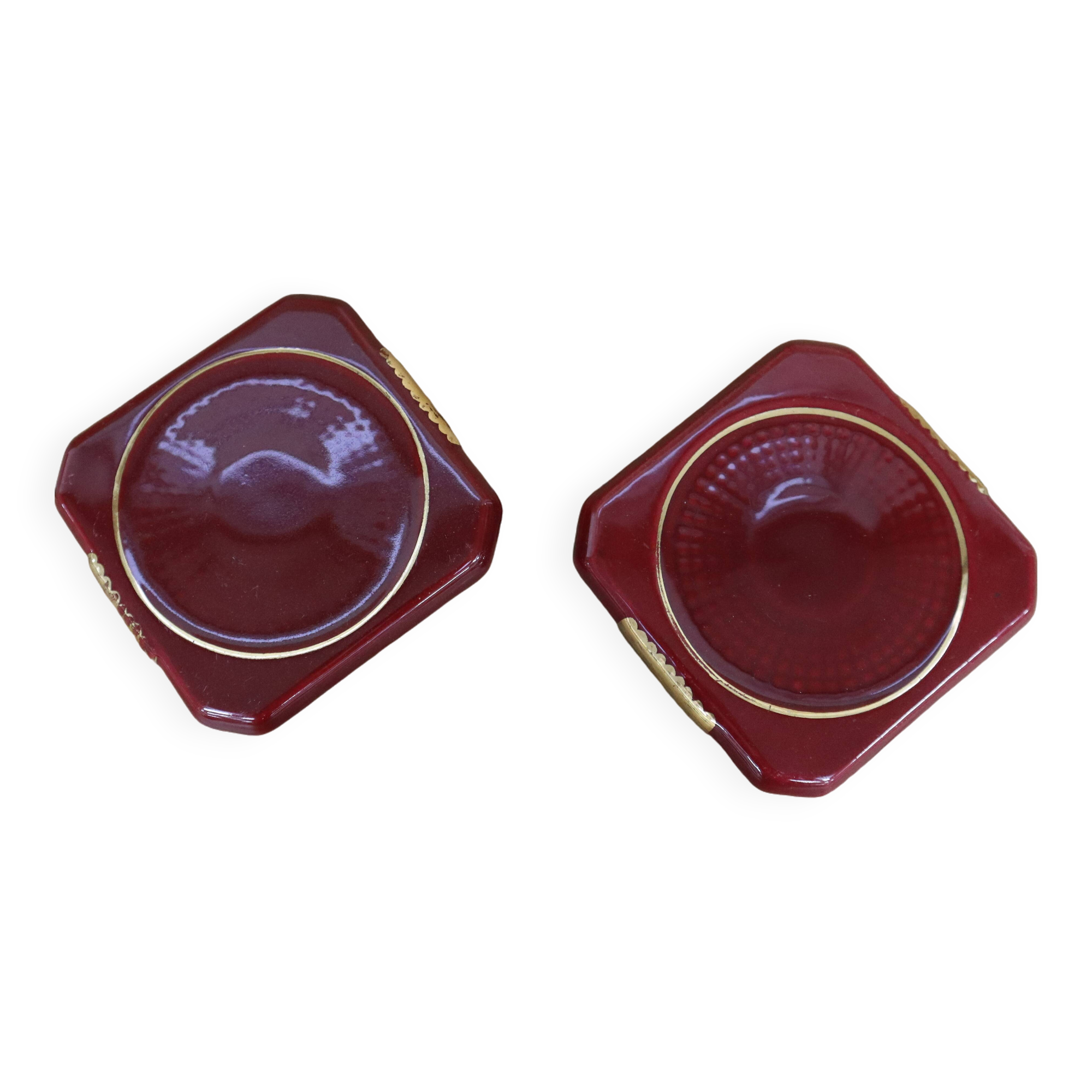 Pair of burgundy ceramic coasters or bottles with gold trim