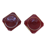 Pair of burgundy ceramic coasters or bottles with gold trim