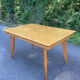 Extendable vintage table with tapered legs.
