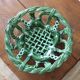 Antique woven basket in green glazed ceramic, fish decoration
