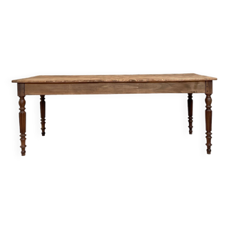 Vintage farmhouse table with turned legs.