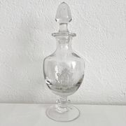 Antique stemmed blown glass bottle with engraved medallion