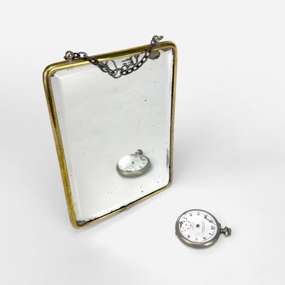 Old barber mirror in brass and beveled glass