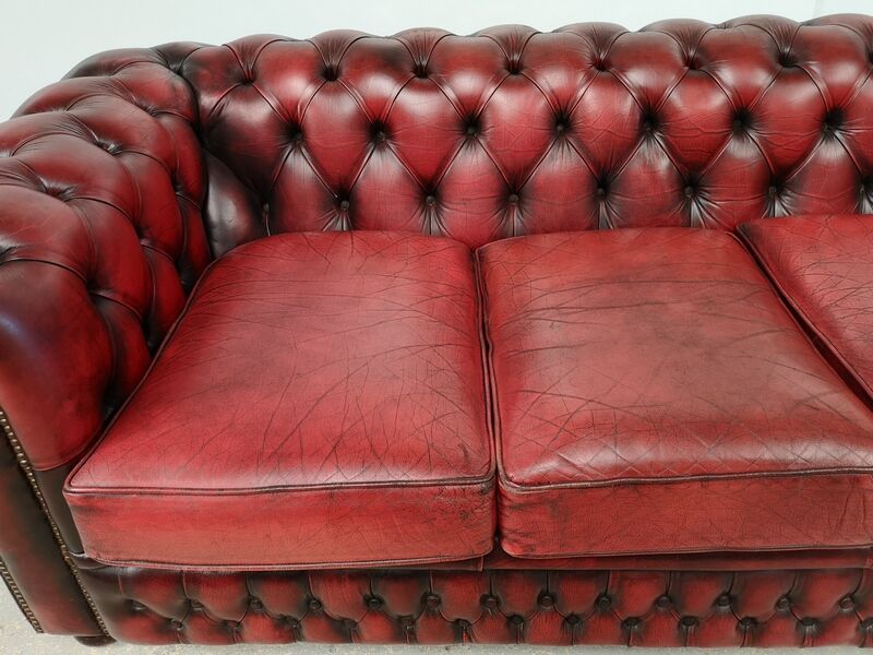 Three-seater red leather chesterfield sofa