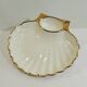 Shell-shaped porcelain pocket bowl from Queen’s Porcelain, with a gold rim.