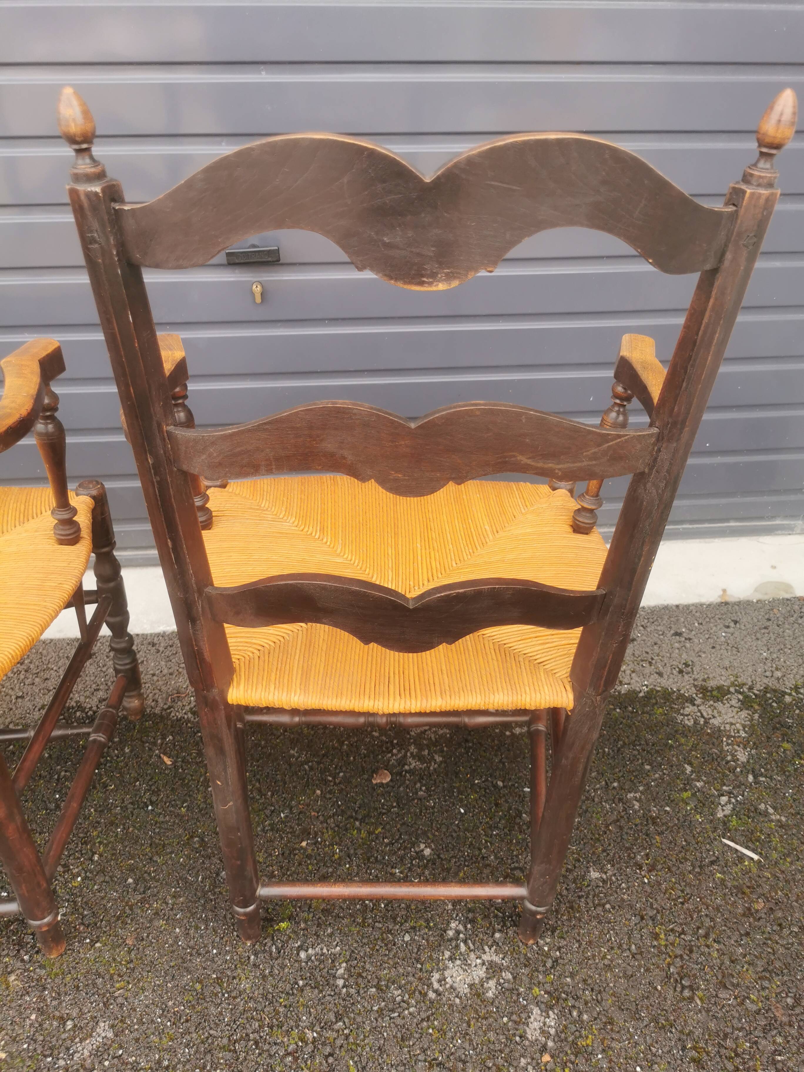 Pair of blackened wooden armchairs