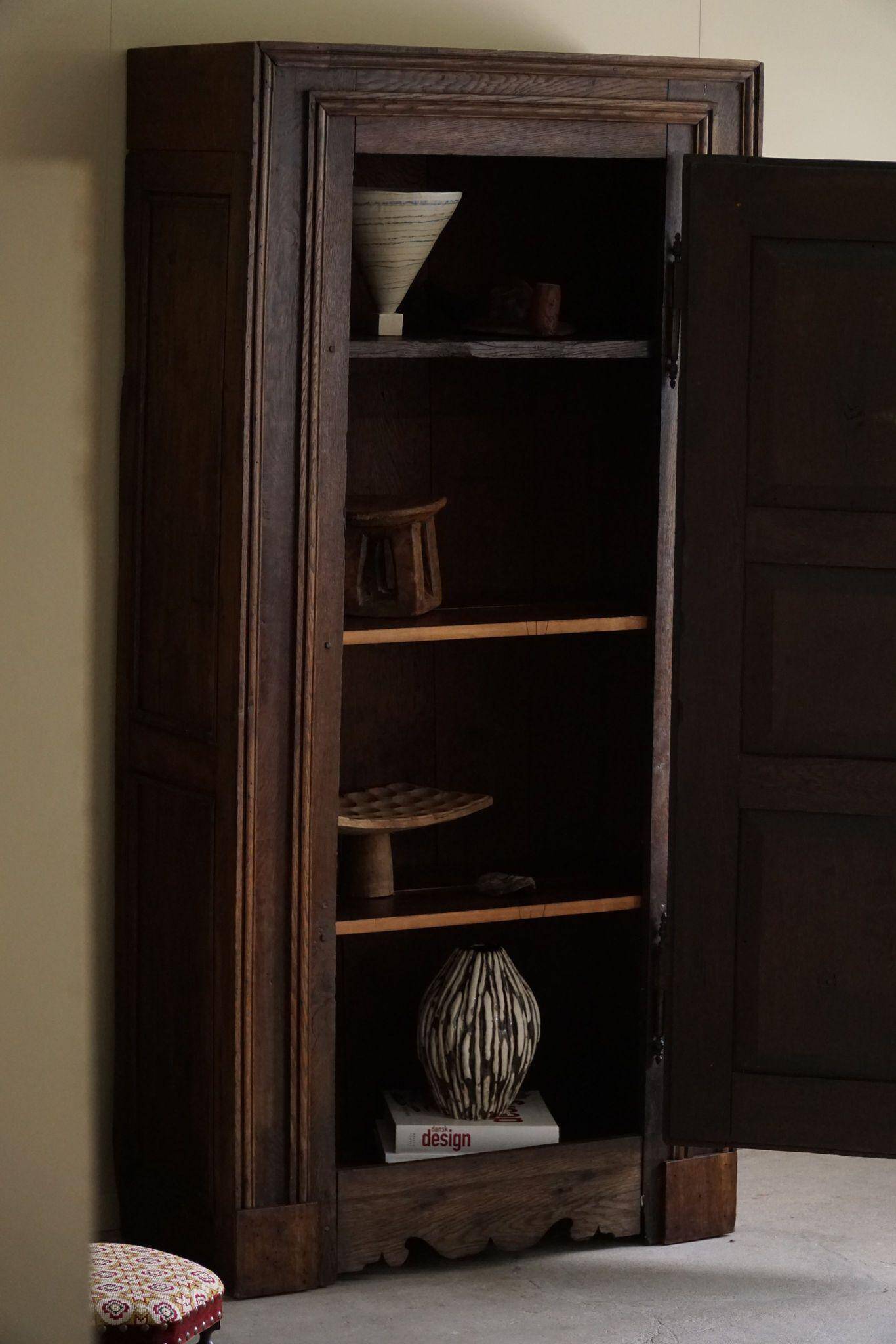 Tall antique oak wardrobe, made by a French cabinetmaker, late 19th century.