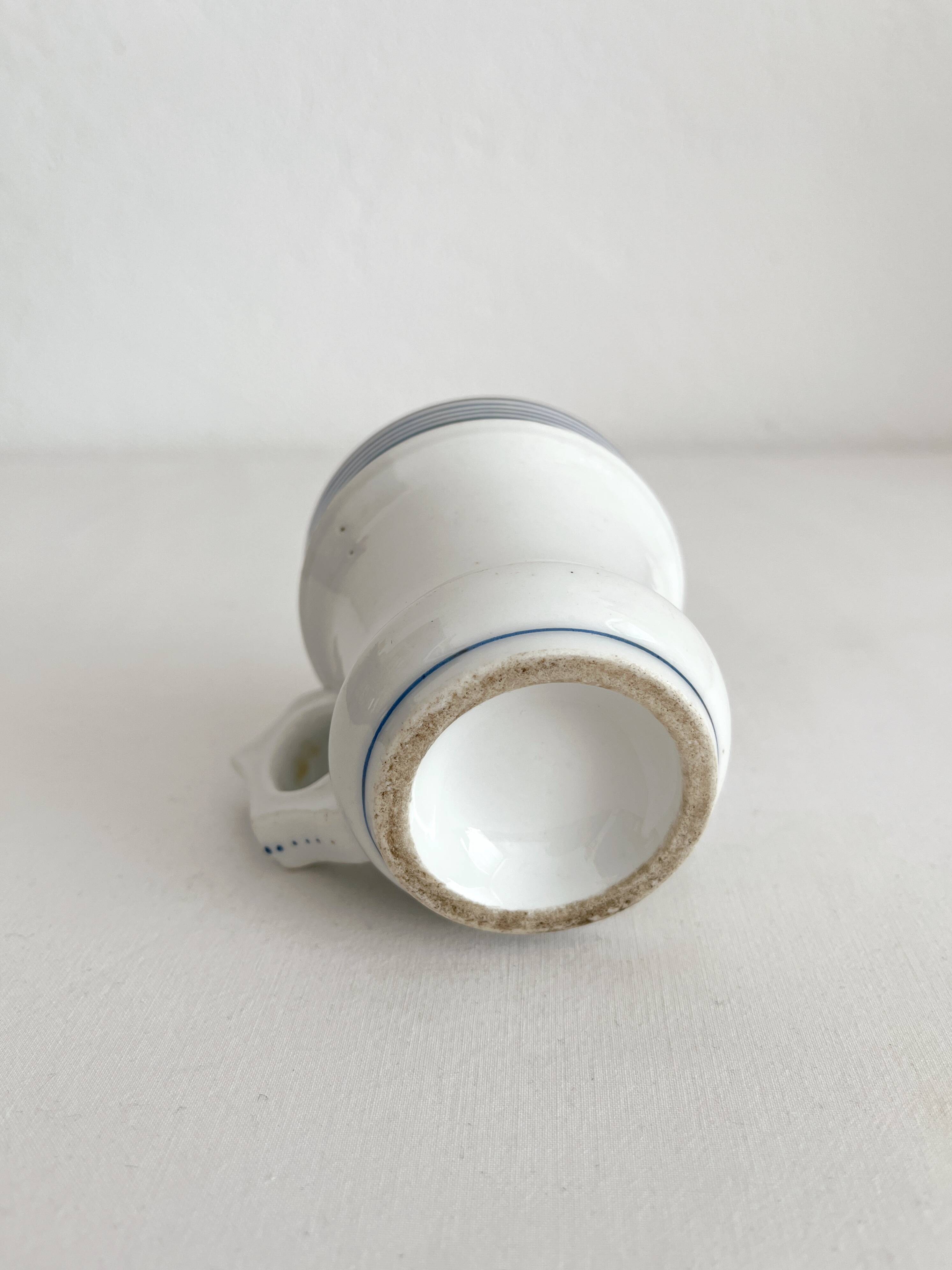 Antique porcelain teacup with blue rims, 19th century