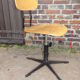 workshop chair adjustable in height, metal footing and seating and wooden back