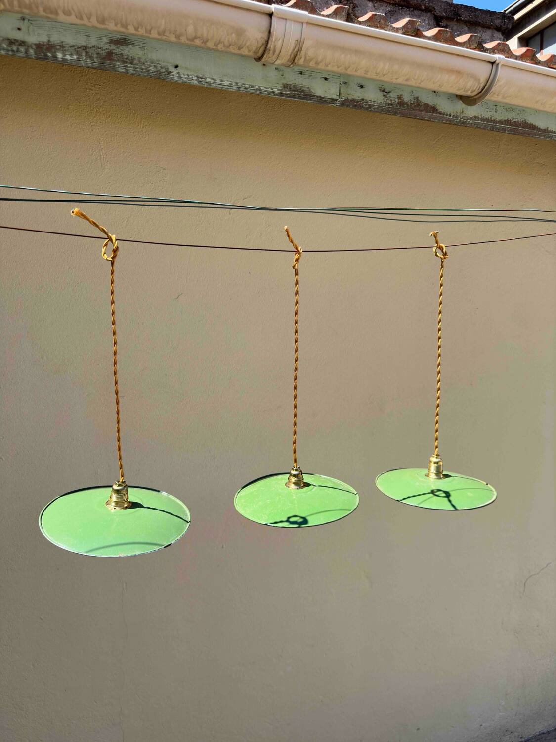 Trio of vintage pendant lampshades in enamelled sheet metal with gold threads