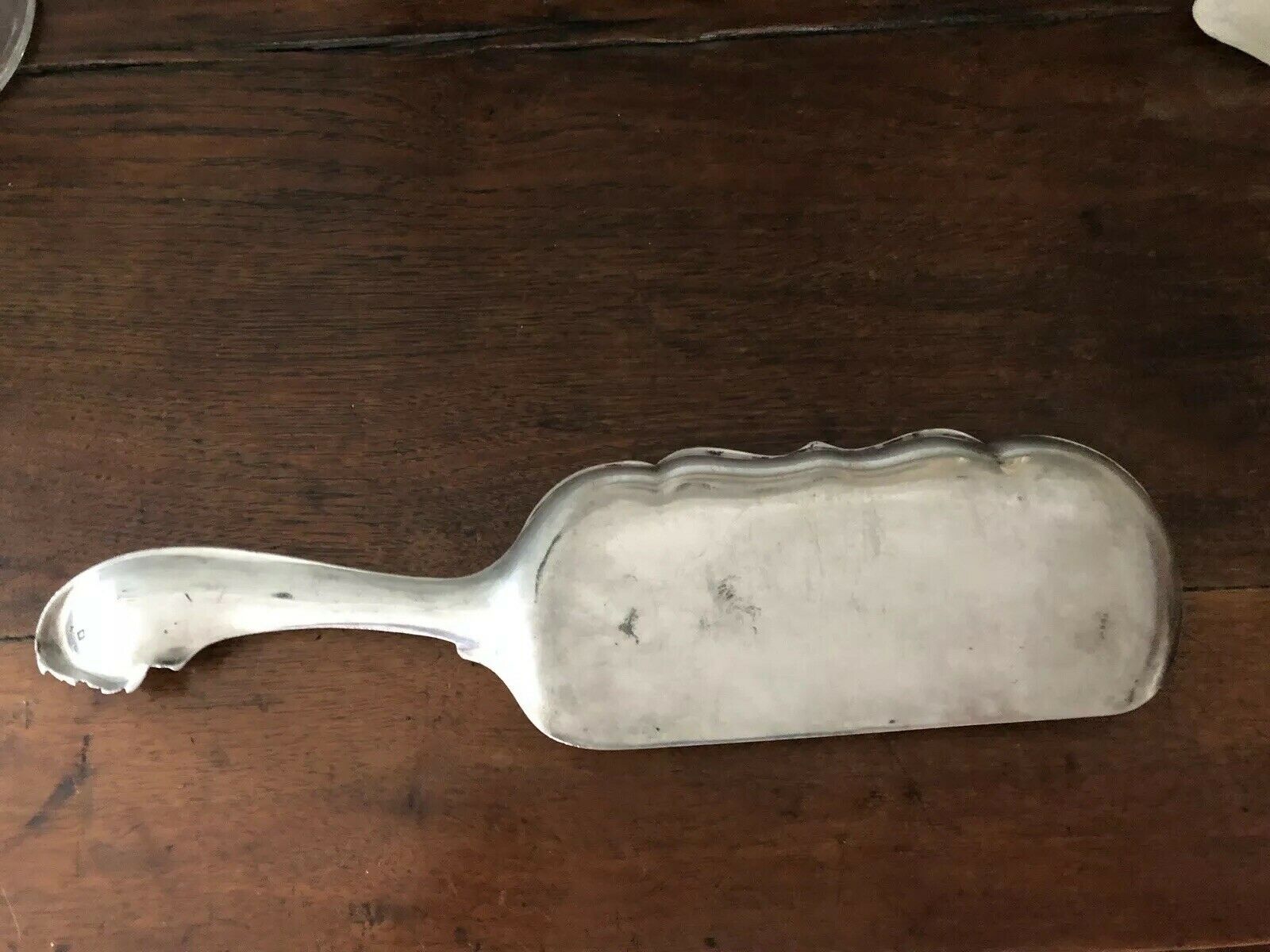 shovel picks up silver table crumbs