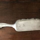 shovel picks up silver table crumbs