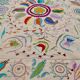 White suzani kilim rug with embroidered multi-colored patterns
