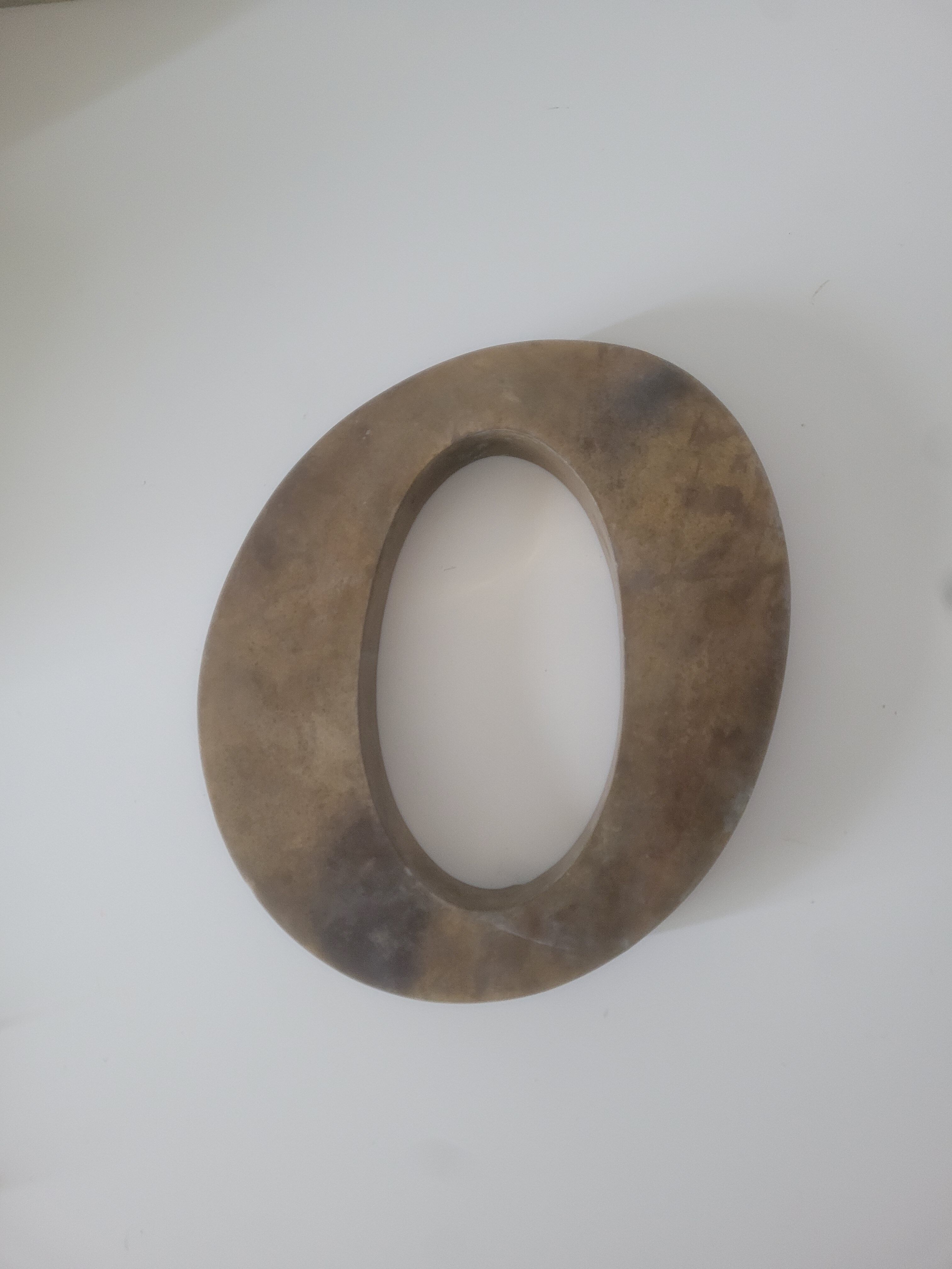 Letter O of sign in vintage gilded brass