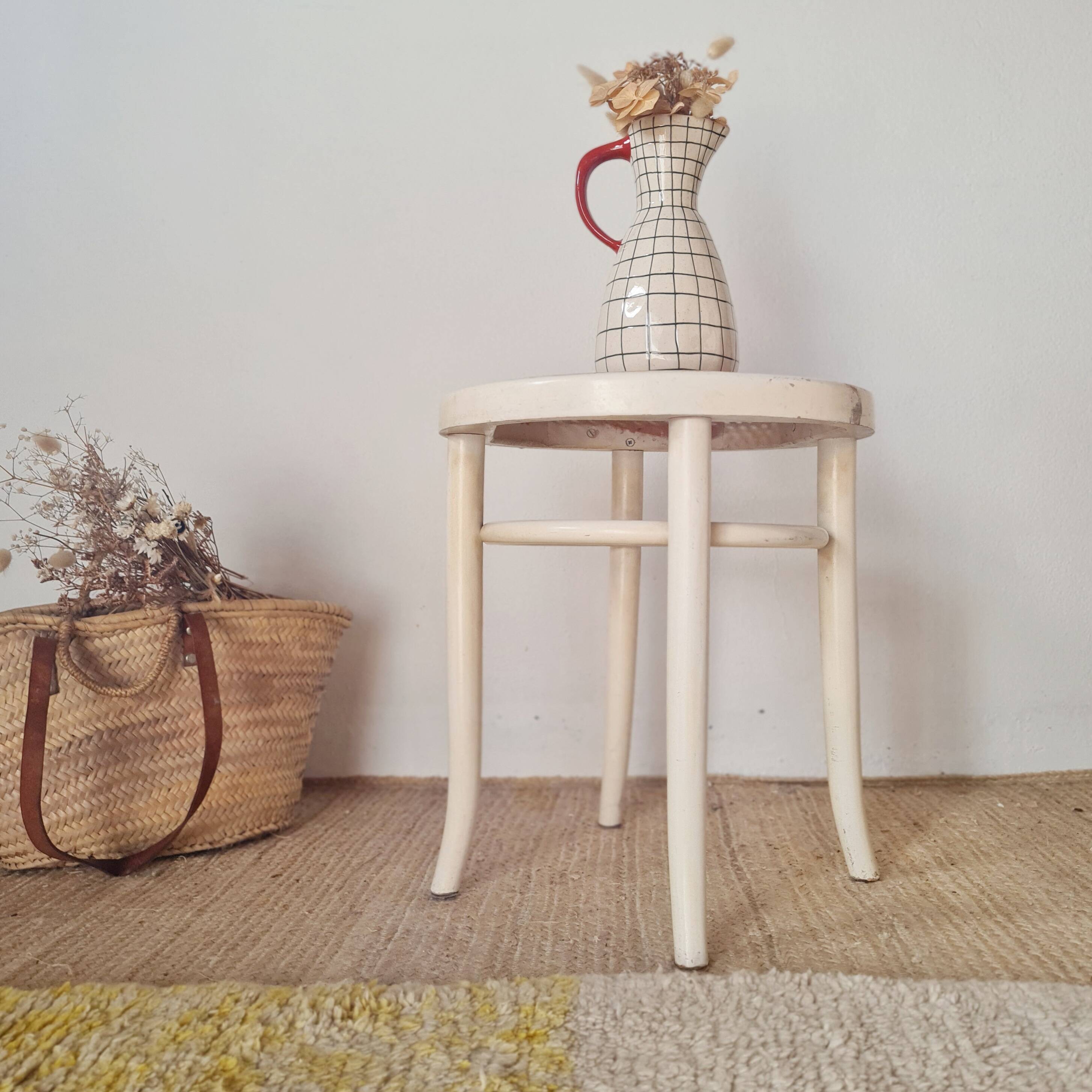 Antique stool with wood and cream caning.