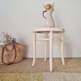 Antique stool with wood and cream caning.
