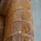 Cognac-colored cowhide 2-seater designer sofa finished with piping