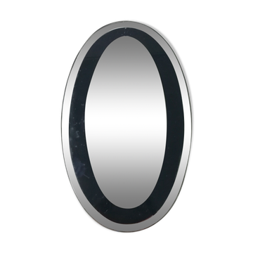 Oval wall lamp with mirror frame. 1980s 18x30cm