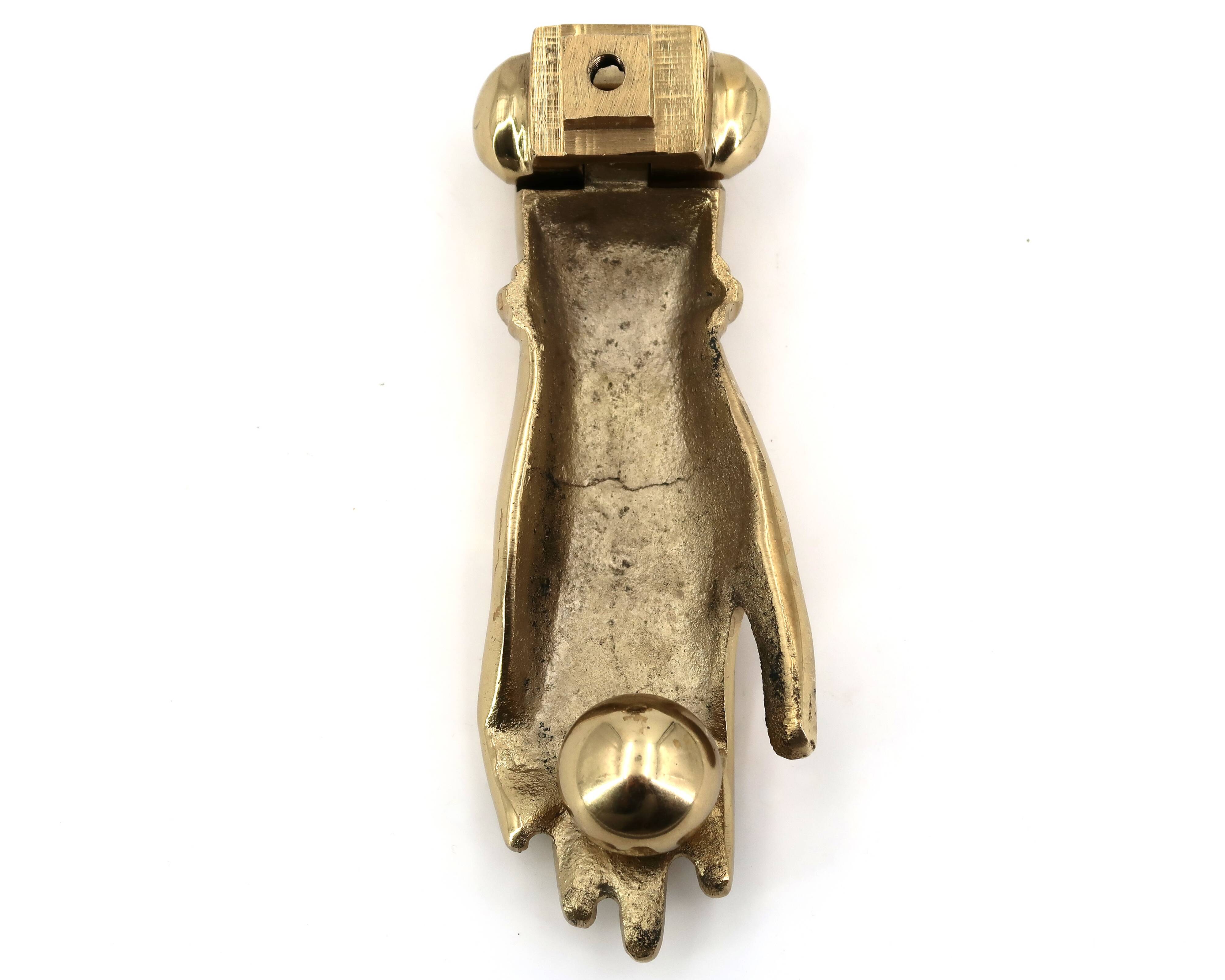 Brass door knocker in the shape of a hand, 1970s.