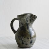 Small handcrafted ceramic pitcher with spotted enamel