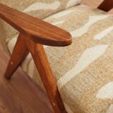 Pair of vintage lounge chairs in brown jacquard fabric and wood.