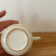 Set of 2 antique earthenware cups with blue floral pattern.