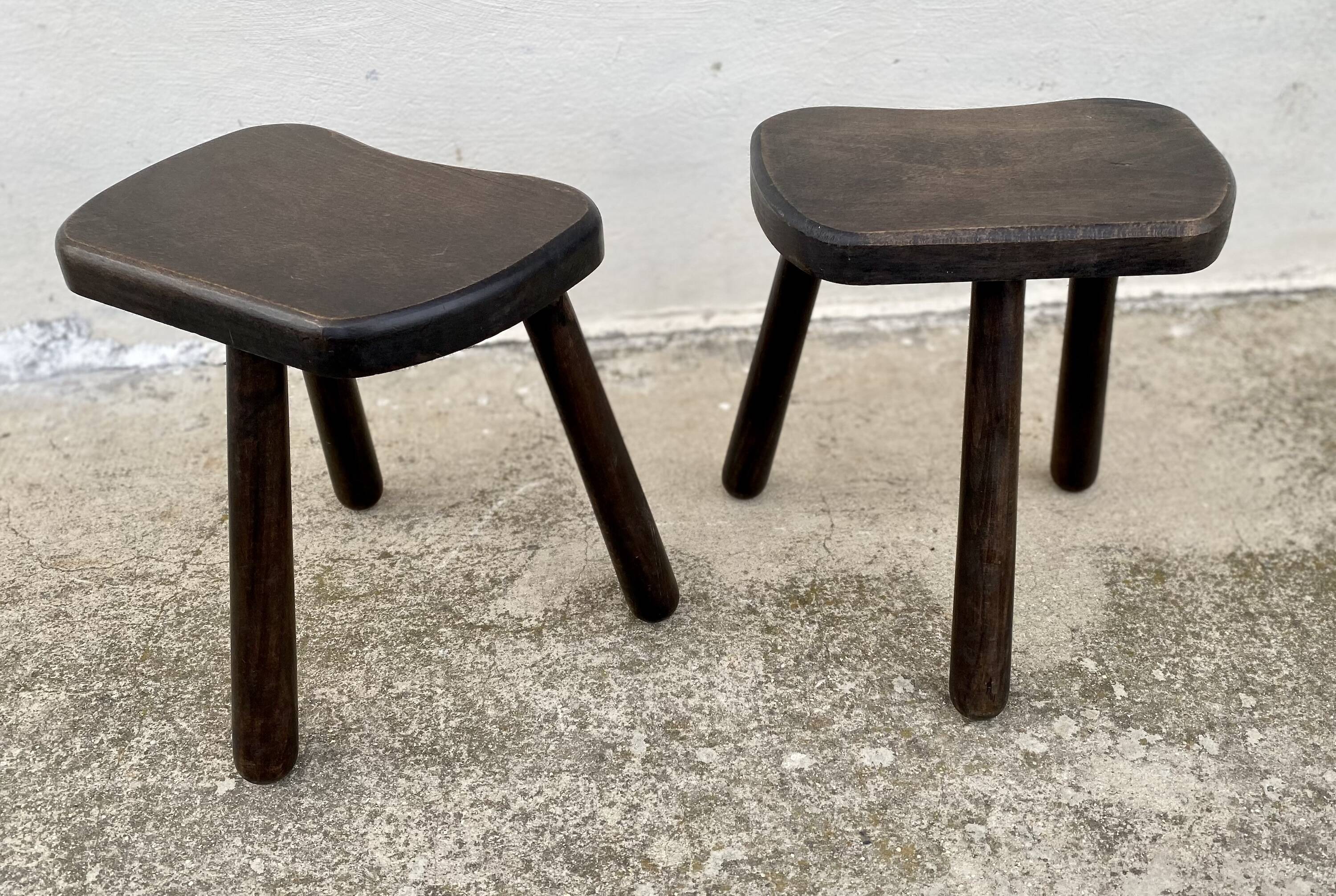 Pair of vintage stained wood tripod stools from the 1970s