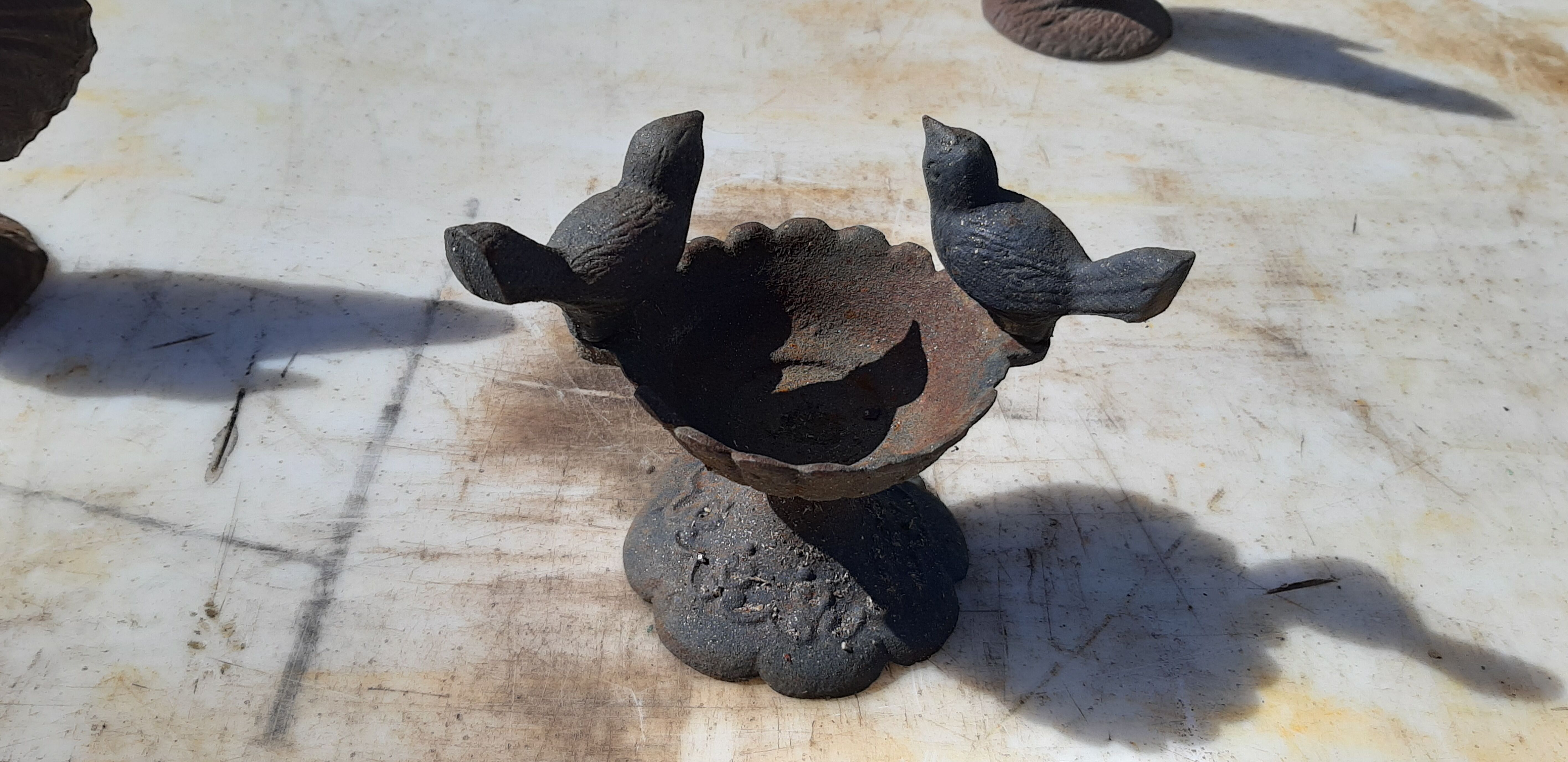 2 roosters and 2 cast iron birds