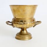Vintage brass cache-pot on a stand with handles, classic decor.