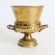 Vintage brass cache-pot on a stand with handles, classic decor.