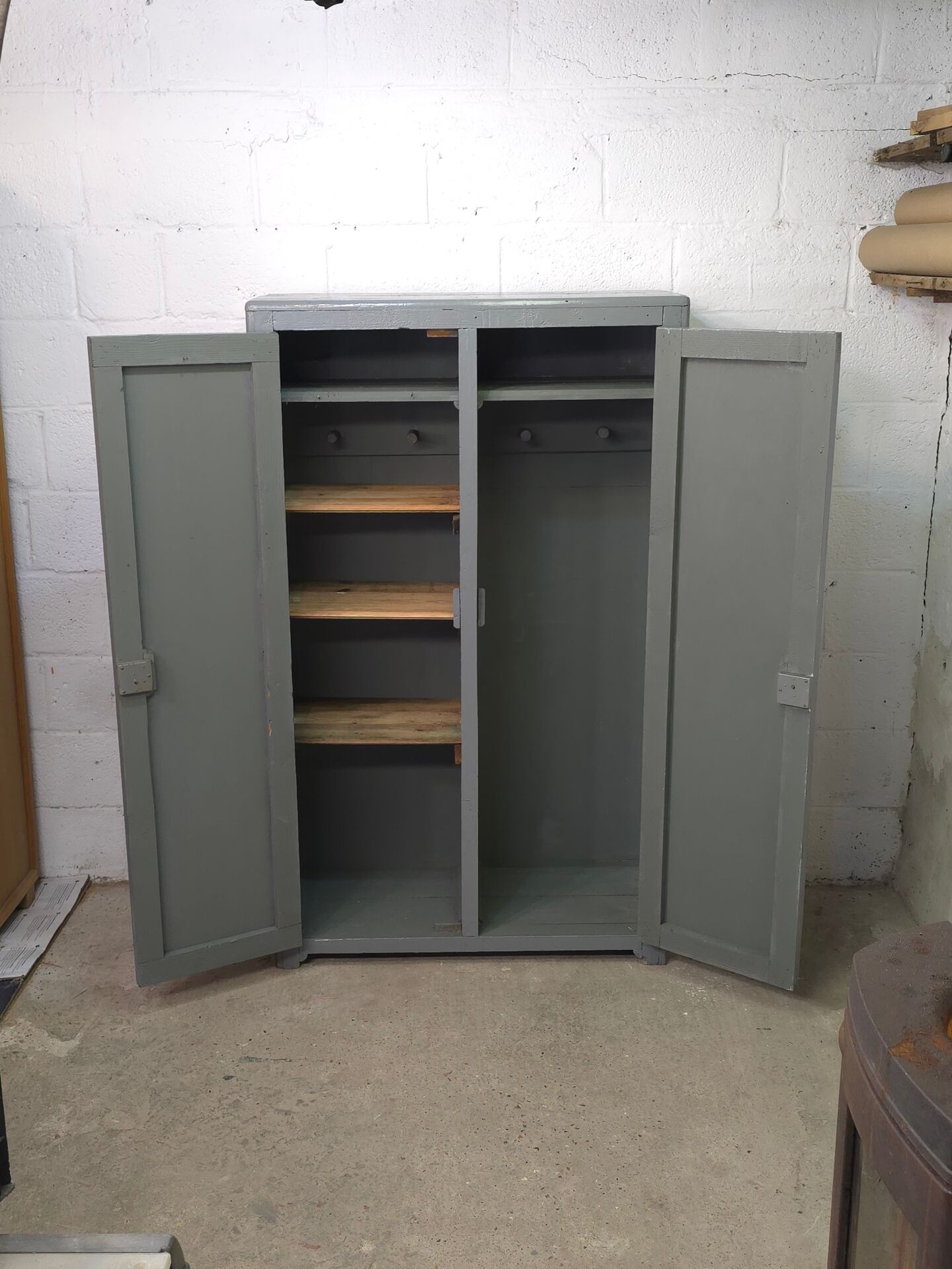 Curved wardrobe workshop locker made of wood repainted in grey.