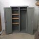 Curved wardrobe workshop locker made of wood repainted in grey.