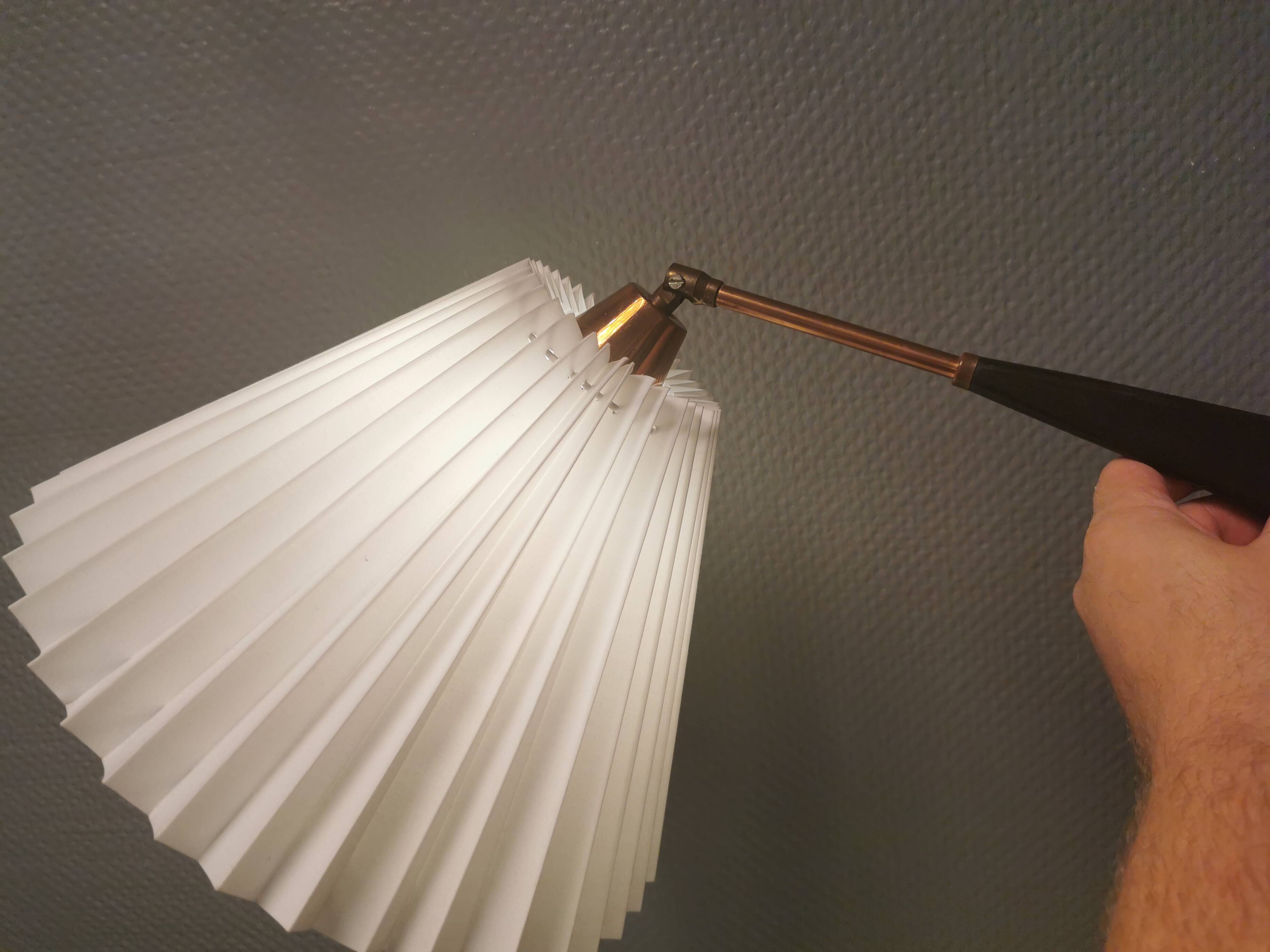 Wall lamp with adjustable ‘arm’ in copper and rosewood, with white shade.