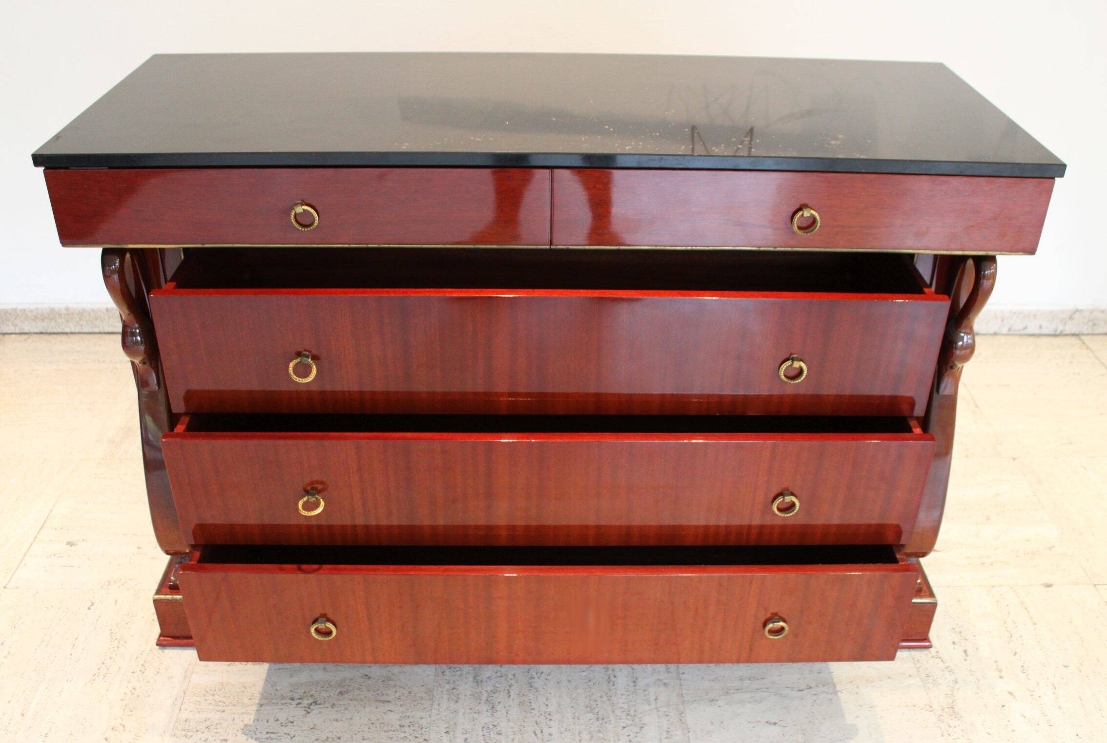 Mahogany “swan neck” chest of drawers, Empire style, 19th century.