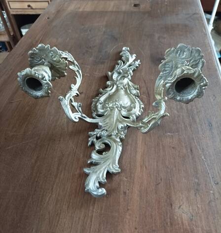 Cast iron wall candle holder with patinated gold metal