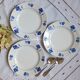 Mismatched old dessert plates accompanied by a dish
