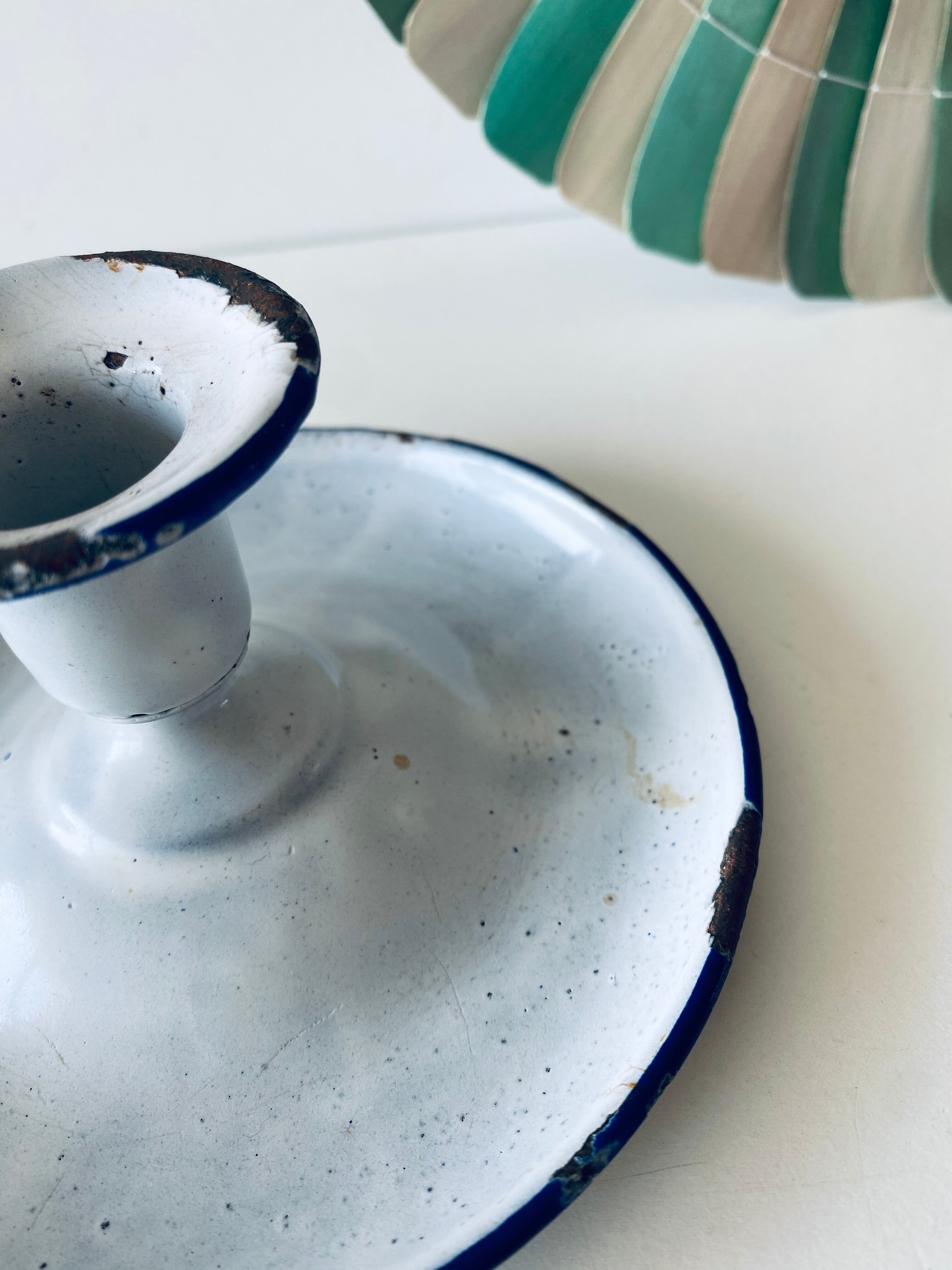 Antique candle holder in white and blue enamelled metal