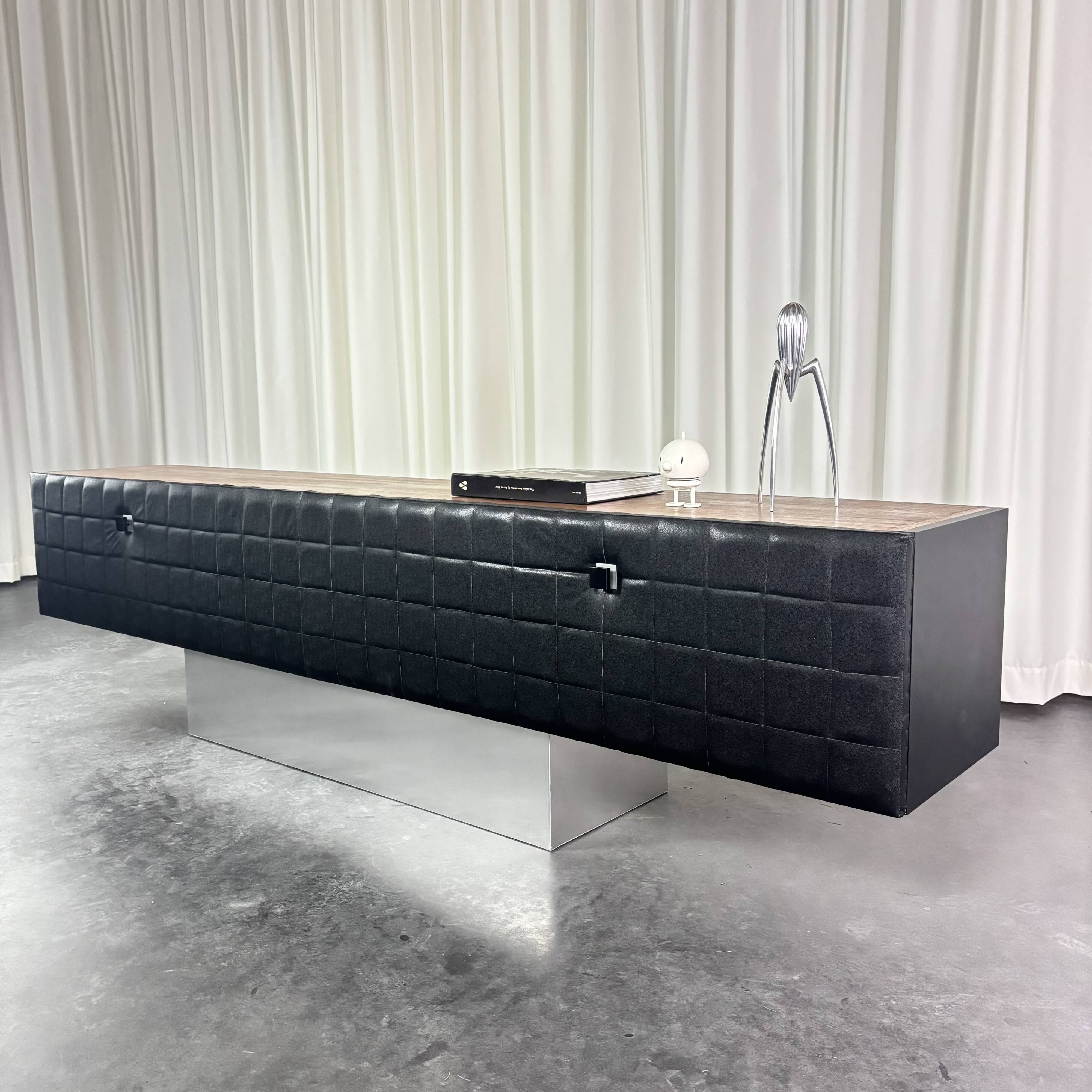 Modernist lowboard, faux leather, wood and stainless steel, 1960.