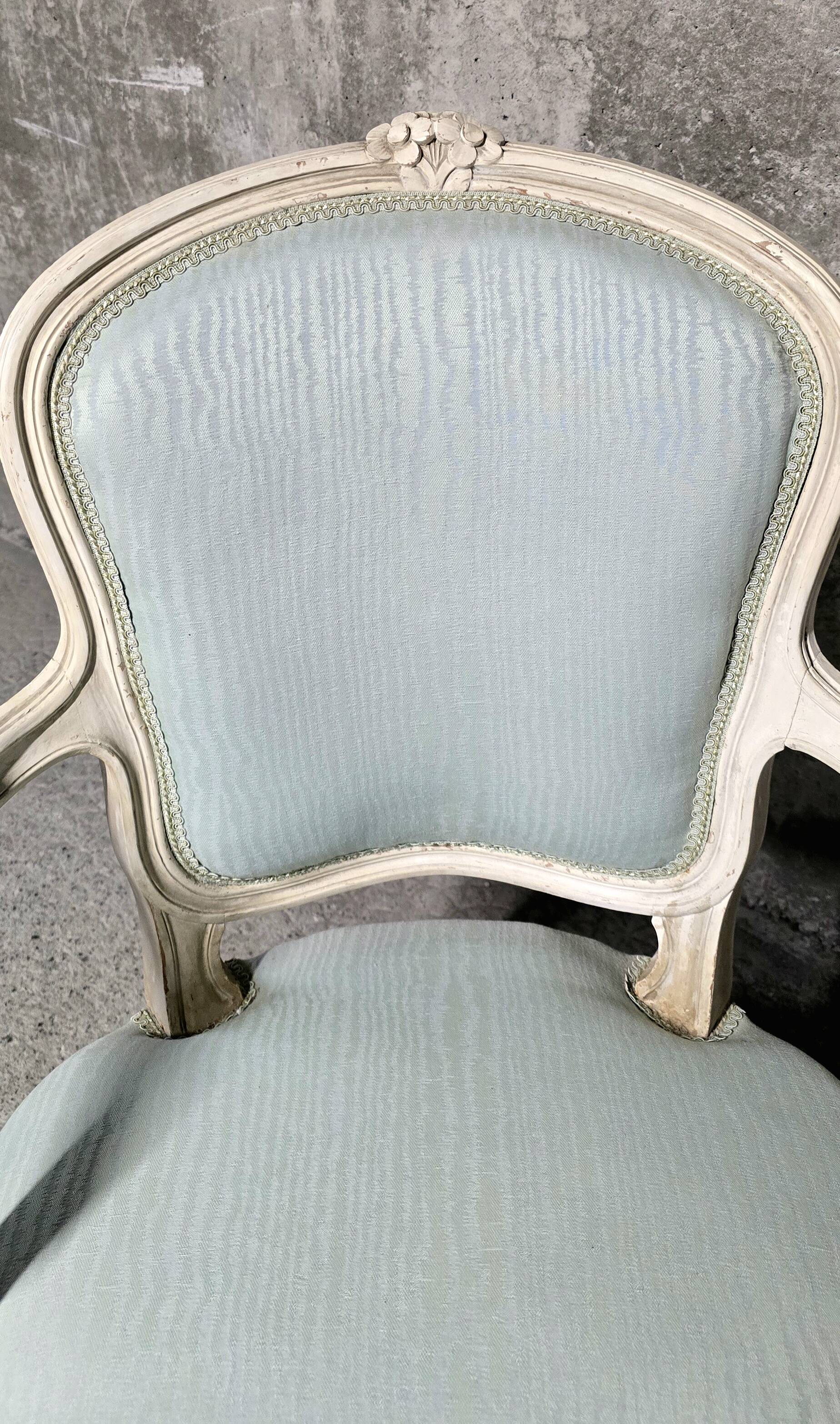 Pair of Louis XV style armchairs in patinated wood, light blue fabric.