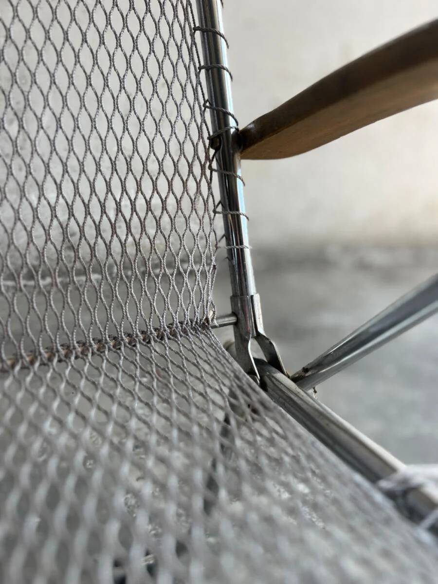 Pair of vintage silver aluminum wire folding chairs with wooden armrests — industrial minimalist