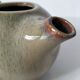 Vintage ceramic teapot with a flame design.